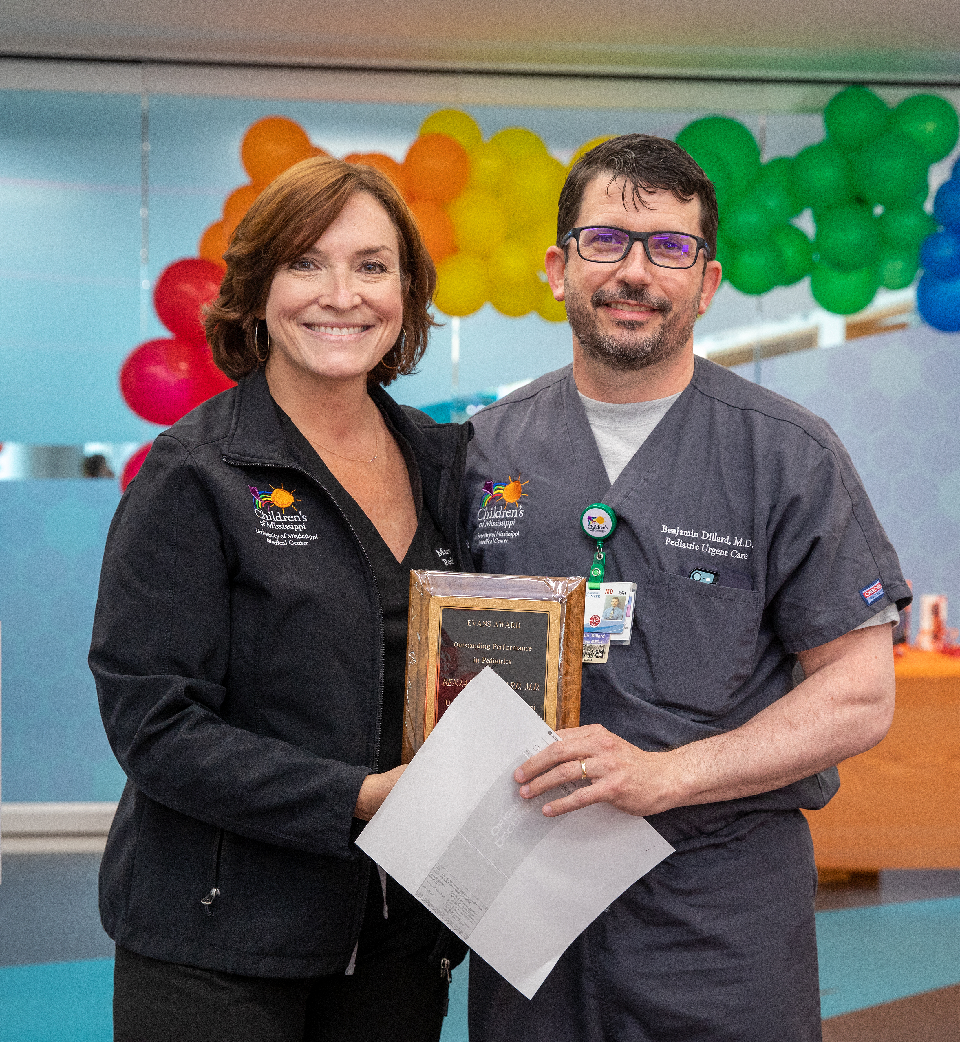 Dr. Mary Taylor presents Dr. Benji Dillard, division director of general pediatrics and pediatric urgent care, with the Evans Award for Outstanding Performance in Pediatrics.